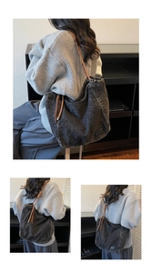 Detail of washed denim tote bag featuring woven rope accent and metal logo patch