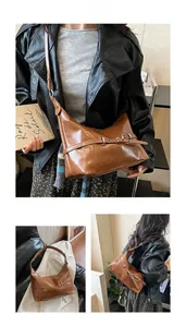 Détail d'un sac à bandoulière en cuir vintage marron avec œillets et boucle argent