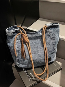 Large capacity vintage washed blue denim tote bag with brown braided rope strap and tassels