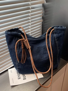 Large denim tote bag with orange rope straps and brown leather tassel for women