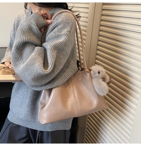Détail d'un grand cabas beige en similicuir souple avec un charmant lapin en peluche