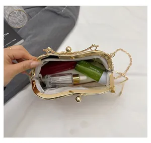Detail of embroidered frame bag interior holding lipstick and small skincare essentials