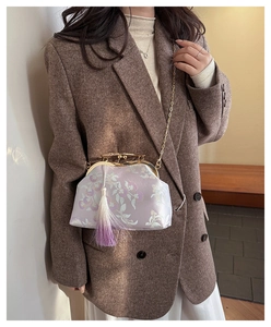 Light purple qipao bag with floral embroidery, metal clasp, and purple tassel pendant