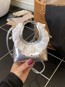 Mini silver metallic handbag with red polka dots and delicate white lace trim