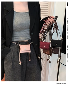 Detail of mini suede crossbody bags in four colors with metallic buckle and long straps