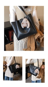 Detail of black faux leather tote bag with a grey plush bunny pendant for daily commute