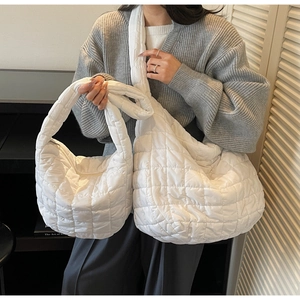 Close-up of white quilted bubble shoulder bag set showing soft texture and puffy stitching