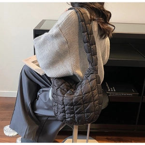 Hobo style quilted bubble bag in black nylon shown on model for daily commuting