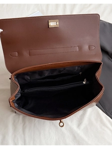 Close-up of brown leather bag interior showing multiple functional compartments and lining