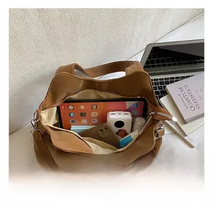 Macro view of the large capacity interior storage in this brown leather tote bag