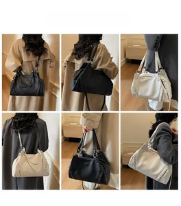 Litchi pattern leather tote bag detail showing shoulder carry style and stitching