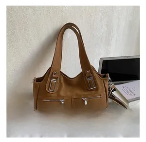 Macro detail of retro brown leather handbag with metallic zippers and textured handle