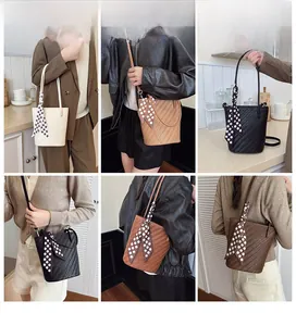 Detail view of woven leather bucket bag with polka dot scarf and adjustable strap