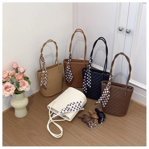 Detailed view of woven tote bags in five colors with decorative polka dot silk scarves