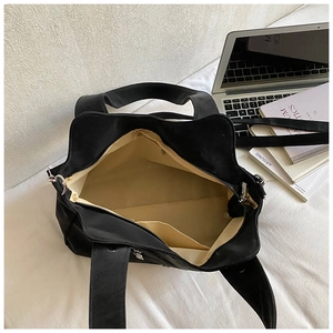 Detailed view of the large black tote bag interior with beige lining and zip closure