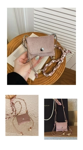 Macro detail of pink suede mini bag with metal buckle and heart print silk scarf strap