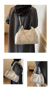 Close-up of cream textured tote showing woven seam details and leather grain finish