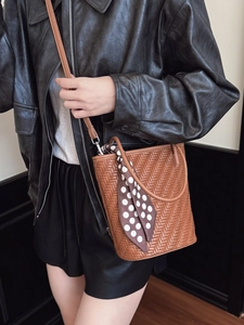 Brown woven bucket bag with polka dot scarf detail and leather strap for women