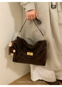 Retro dark brown suede underarm bag with gold twist lock and a cute plush bear charm