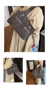 Detail of vintage brown tote bag showing textured washed leather and front zip pockets