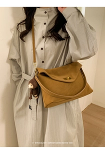 Retro mustard yellow shoulder bag with gold twist lock and cute bear charm detail