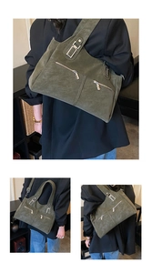 Close-up of olive green tote bag featuring decorative silver zippers and matte texture