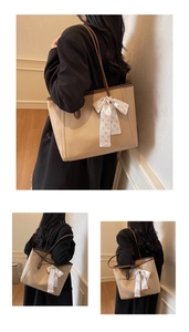 Detail of beige tote bag with brown straps and an elegant quilted silk bow accessory