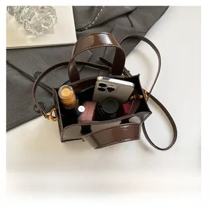 Internal capacity of the brown patent leather crossbody bag with smartphone and cosmetics