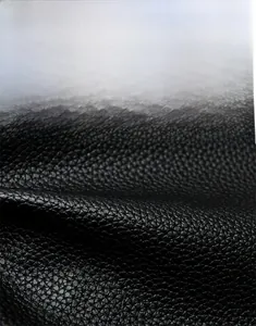 Detailed macro view of black litchi texture synthetic leather showing wear-resistant quality