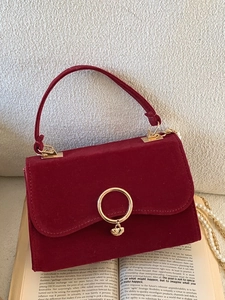 Elegant wine red velvet handbag with golden heart clasp and pearl chain strap