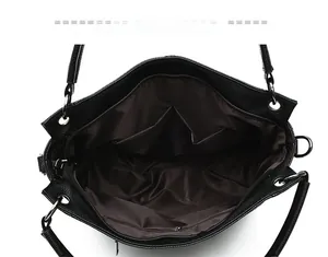 Top view of spacious black leather tote interior with brown lining and multiple pockets