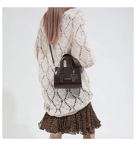 Chocolate brown faux leather crossbody bag worn by model to show product scale and style