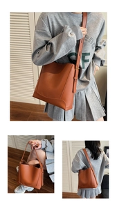 Detail of caramel leather bucket bag featuring reinforced stitching and adjustable shoulder strap