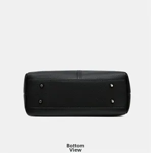 Close-up of black pebbled leather bag bottom with four protective silver metal feet