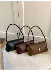 Detailed view of vintage baguette bags in black, chocolate, and caramel with gold oval buckles