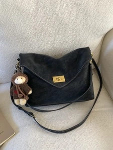 Retro minimalist black shoulder bag with gold twist lock and cute teddy bear charm