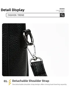 Detail of detachable shoulder strap with silver D-ring buckle on black leather tote