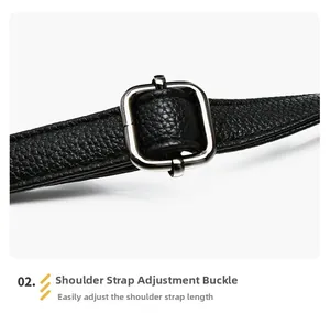 Detail of black pebbled leather strap with adjustable silver metal buckle on tote bag