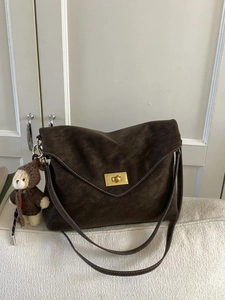 Brown suede shoulder bag with gold twist lock and white contrast stitching detail