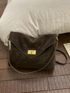 Retro dark brown suede shoulder bag with golden buckle and white stitching detail