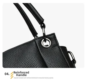Detail of reinforced handle with metal ring and stitching on black pebbled leather tote