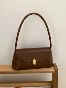 Retro dark brown leather baguette underarm bag with an oval gold buckle closure