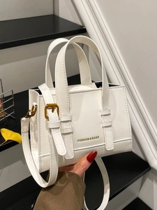 White vintage square crossbody bag with gold buckles and fashion logo on leather