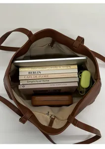 Interior view showing the large capacity of the brown PU leather tote bag with pockets
