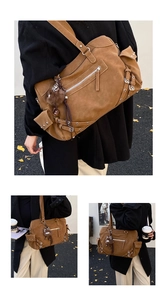 Detail of brown suede tote bag with zipper pockets, metal studs and plush pompom charm