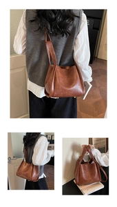 Detail der braunen Vintage-Leder-Einkaufstasche mit Metallfüßen und Textur-Finish