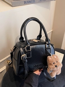 Classic black Boston handbag with puppy charm and detachable shoulder strap for daily use