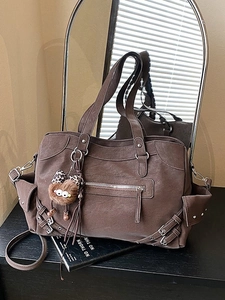 Large dark brown vintage tote bag with functional pockets and leopard plush charm