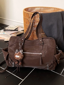 Large dark brown tote bag with multiple pockets and plush leopard bow charm decoration