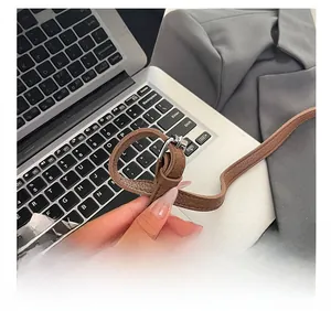 Detail view of adjustable dark brown pebble grain leather strap with silver buckle